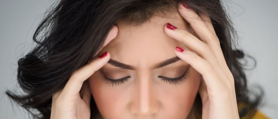 Woman with headache from neck problems